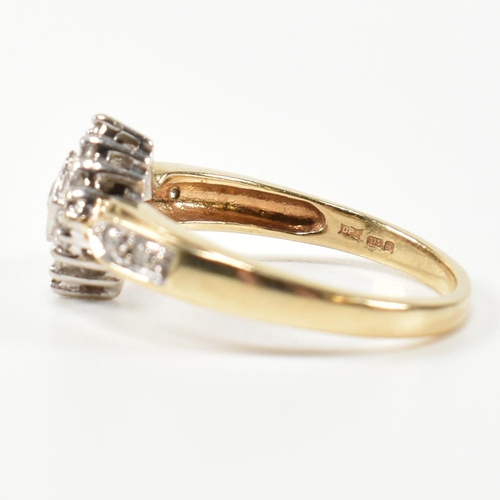 324 - A hallmarked 9ct gold and diamond cluster ring. The ring having a central round brilliant cut diamon... 