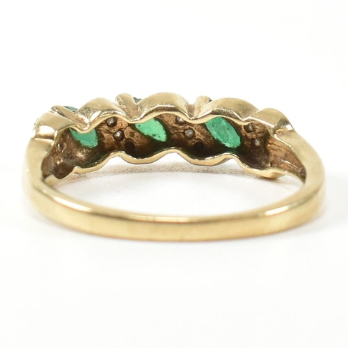 328 - A 9ct gold, diamond and emerald twist band ring. The ring set with three marquise cut emeralds inter... 