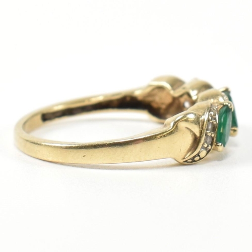 328 - A 9ct gold, diamond and emerald twist band ring. The ring set with three marquise cut emeralds inter... 