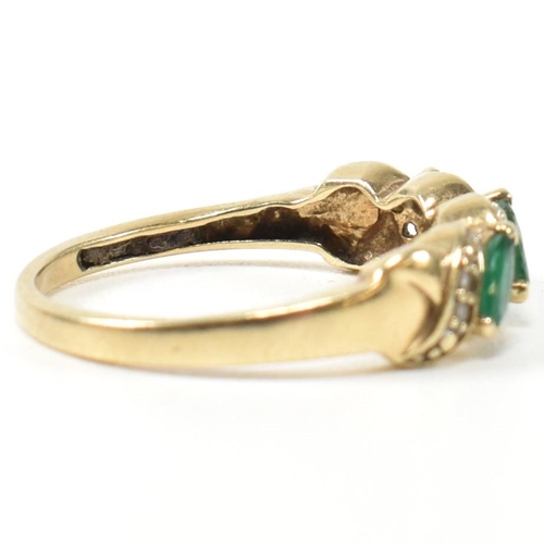 328 - A 9ct gold, diamond and emerald twist band ring. The ring set with three marquise cut emeralds inter... 