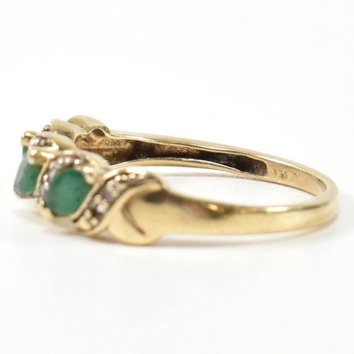 328 - A 9ct gold, diamond and emerald twist band ring. The ring set with three marquise cut emeralds inter... 