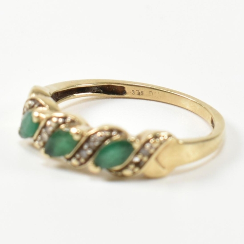 328 - A 9ct gold, diamond and emerald twist band ring. The ring set with three marquise cut emeralds inter... 