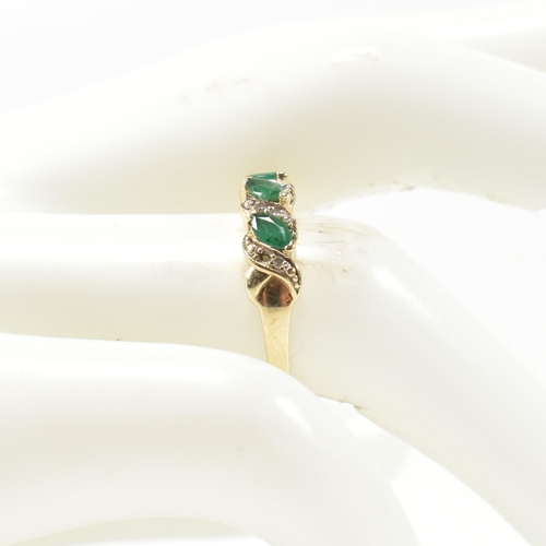 328 - A 9ct gold, diamond and emerald twist band ring. The ring set with three marquise cut emeralds inter... 