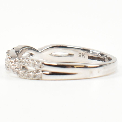 33 - A hallmarked 9ct gold and diamond crossover ring. The ring formed with entwined channels of round br... 