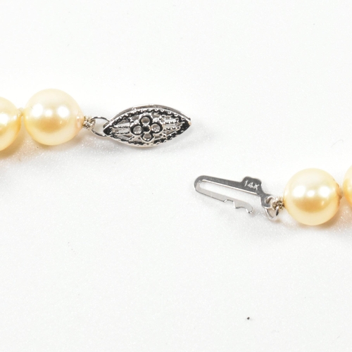 331 - 14ct white gold and cultured pearl necklace. The necklace strung with a single row of cultured pearl... 