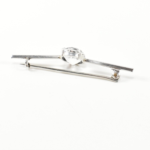 334 - Two white stone set brooch pins. The brooches to include a silver bar brooch set with a double claw ... 