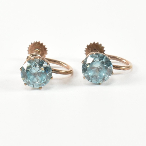 335 - A pair of 9ct gold and zircon earrings. The earrings having a single six claw set round cut zircon t... 