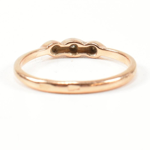 338 - A hallmarked 14ct rose gold and white stone ring. The rose gold ring set with three round cut white ... 