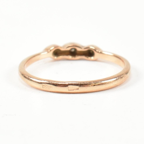 338 - A hallmarked 14ct rose gold and white stone ring. The rose gold ring set with three round cut white ... 