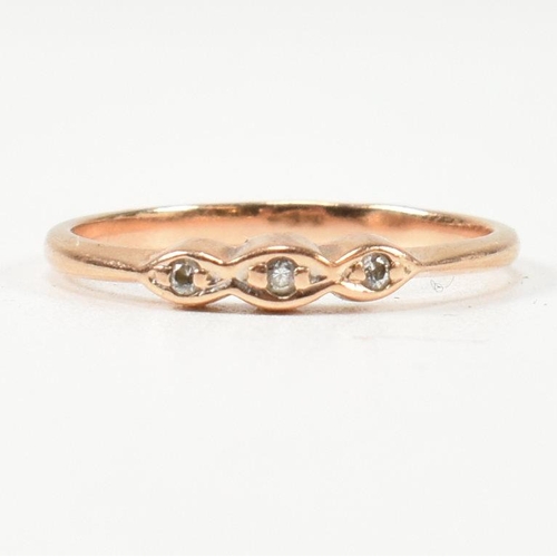 338 - A hallmarked 14ct rose gold and white stone ring. The rose gold ring set with three round cut white ... 