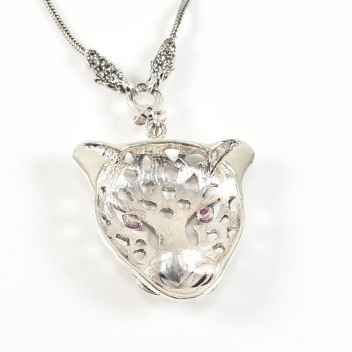 343 - A silver gem set leopards head pendant necklace. The pendant set with ruby marcasite. Marked 925. Me... 