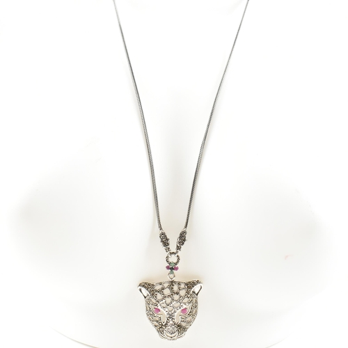 343 - A silver gem set leopards head pendant necklace. The pendant set with ruby marcasite. Marked 925. Me... 