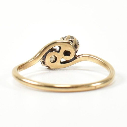 344 - A 9ct gold and CZ cross over ring. The ring having two round cut CZs set in a cross over mount to cu... 