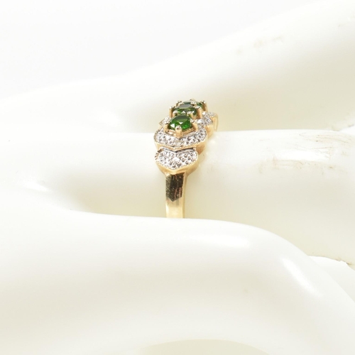 345 - A hallmarked 9ct gold, diopside and diamond three stone ring. The ring having three round cut diopsi... 