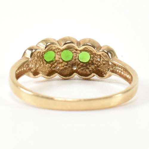 345 - A hallmarked 9ct gold, diopside and diamond three stone ring. The ring having three round cut diopsi... 