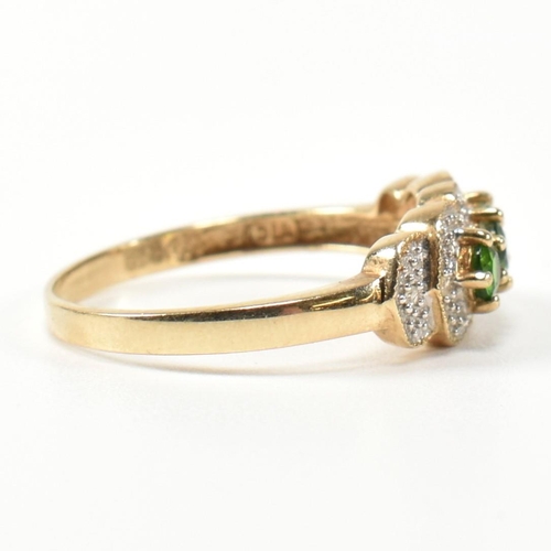 345 - A hallmarked 9ct gold, diopside and diamond three stone ring. The ring having three round cut diopsi... 