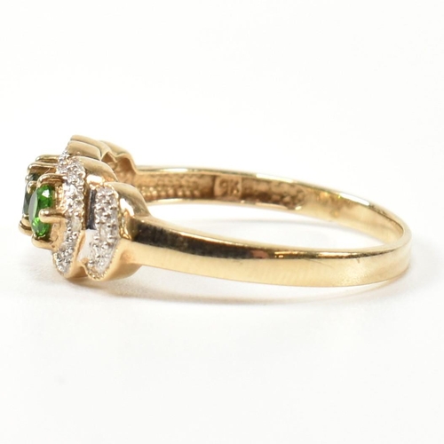 345 - A hallmarked 9ct gold, diopside and diamond three stone ring. The ring having three round cut diopsi... 