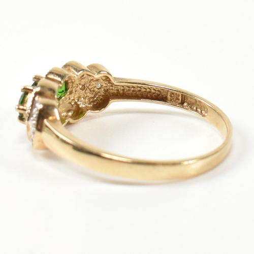 345 - A hallmarked 9ct gold, diopside and diamond three stone ring. The ring having three round cut diopsi... 