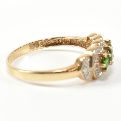 345 - A hallmarked 9ct gold, diopside and diamond three stone ring. The ring having three round cut diopsi... 