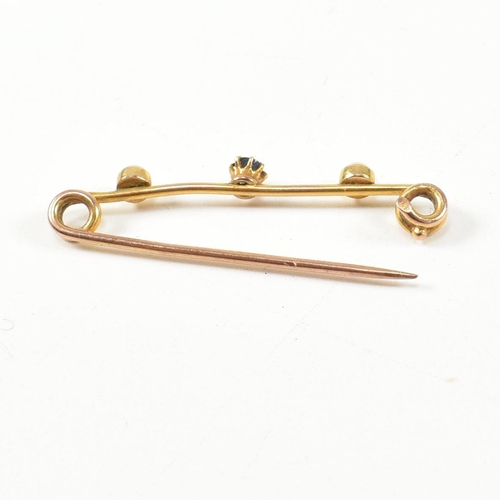 346 - A gold, sapphire and pearl brooch pin. The brooch pin set with a central oval cut sapphire flanked b... 