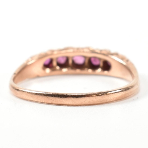 348 - A hallmarked 9ct rose gold and ruby five stone gypsy ring. The ring having five graduating round cut... 