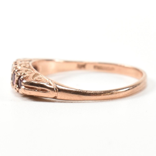 348 - A hallmarked 9ct rose gold and ruby five stone gypsy ring. The ring having five graduating round cut... 