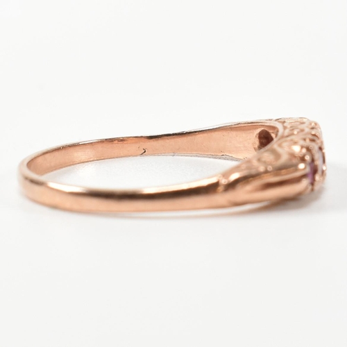 348 - A hallmarked 9ct rose gold and ruby five stone gypsy ring. The ring having five graduating round cut... 