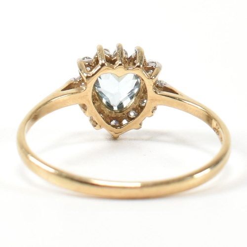 349 - A hallmarked 9ct gold, topaz and CZ heart cluster ring. The 9ct gold set with a central heart cut to... 