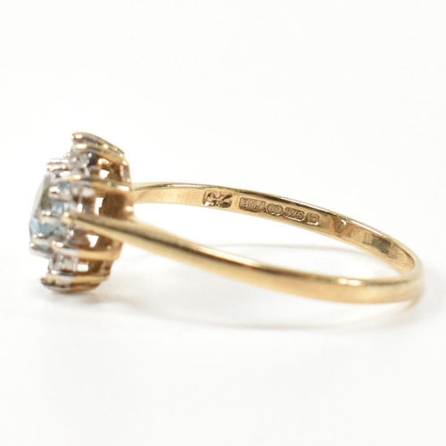 349 - A hallmarked 9ct gold, topaz and CZ heart cluster ring. The 9ct gold set with a central heart cut to... 