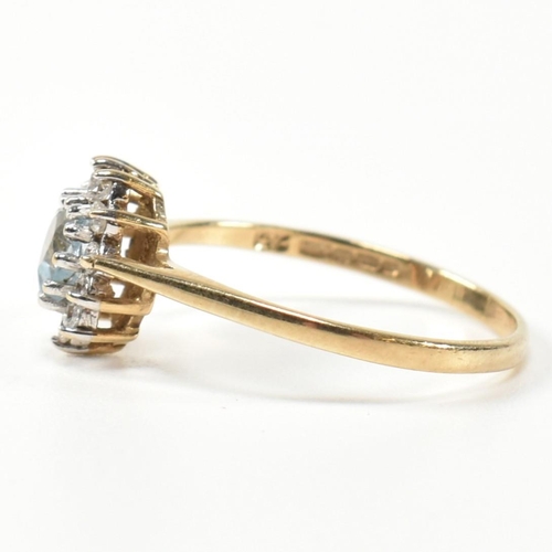 349 - A hallmarked 9ct gold, topaz and CZ heart cluster ring. The 9ct gold set with a central heart cut to... 