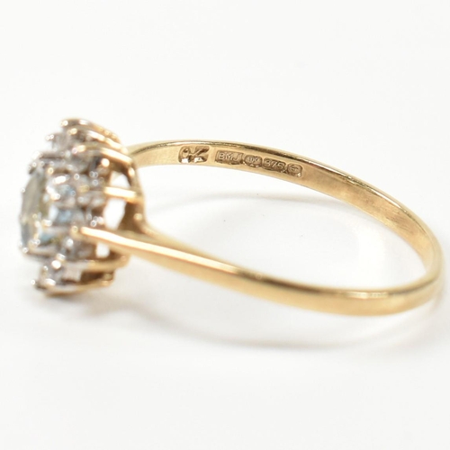 349 - A hallmarked 9ct gold, topaz and CZ heart cluster ring. The 9ct gold set with a central heart cut to... 