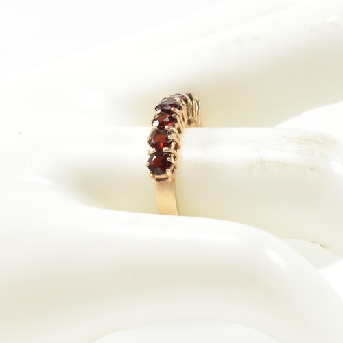 353 - A hallmarked 9ct gold and garnet seven stone half hoop ring. The 9ct gold ring having a row of seven... 