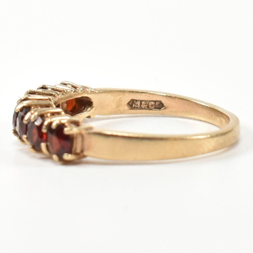 353 - A hallmarked 9ct gold and garnet seven stone half hoop ring. The 9ct gold ring having a row of seven... 