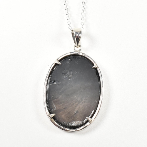 360 - Silver cameo pendant necklace. The necklace strung with a cameo pendant depicting a long haired cat.... 