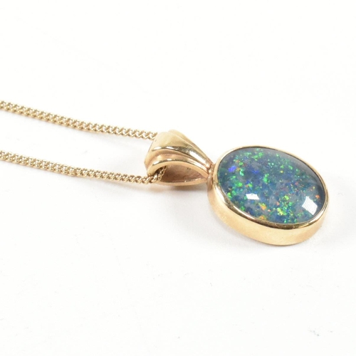 363 - A hallmarked 9ct gold and opal doublet pendant necklace. The necklace having a bezel set opal double... 