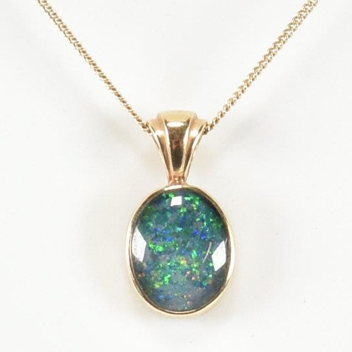 363 - A hallmarked 9ct gold and opal doublet pendant necklace. The necklace having a bezel set opal double... 