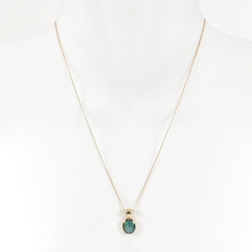 363 - A hallmarked 9ct gold and opal doublet pendant necklace. The necklace having a bezel set opal double... 