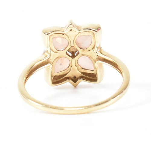 370 - A hallmarked 9ct gold sunstone and diamond cluster ring. The ring having a clover shaped mount set w... 