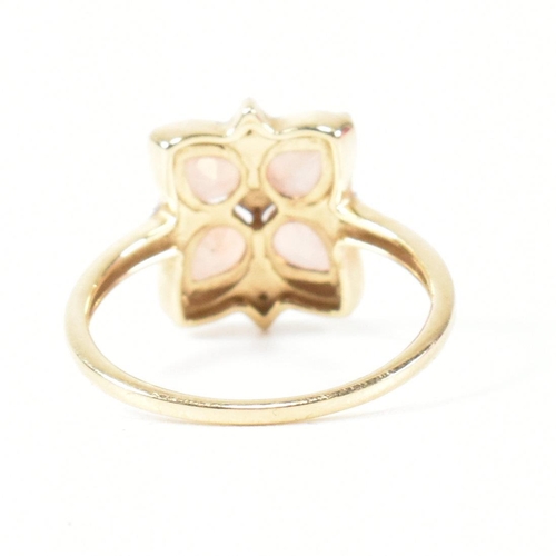 370 - A hallmarked 9ct gold sunstone and diamond cluster ring. The ring having a clover shaped mount set w... 