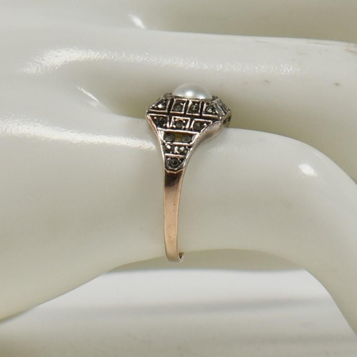 372 - A 9ct gold, pearl and marcasite ring. The Art Deco style ring having a central pearl set in a marcas... 