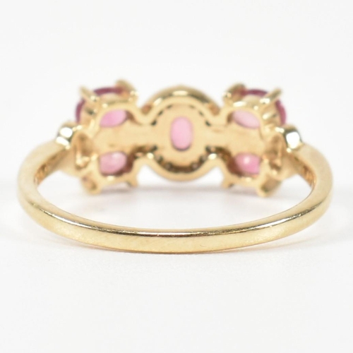 377 - A hallmarked 9ct gold, pink sapphire and diamond ring. The ring having a central oval cut pink sapph... 