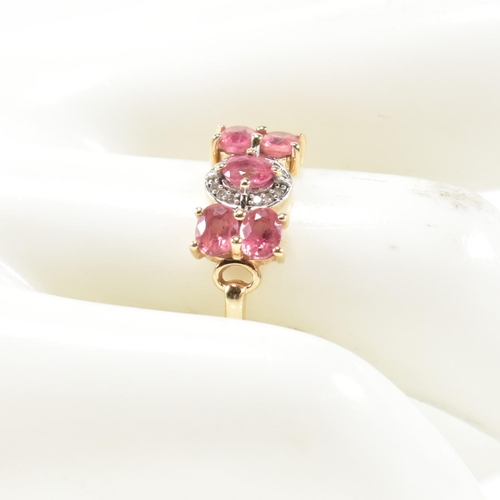 377 - A hallmarked 9ct gold, pink sapphire and diamond ring. The ring having a central oval cut pink sapph... 