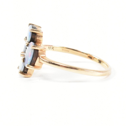 378 - A hallmarked 9ct gold and opal doublet ring. The ring having four button prong set oval cut opal dou... 