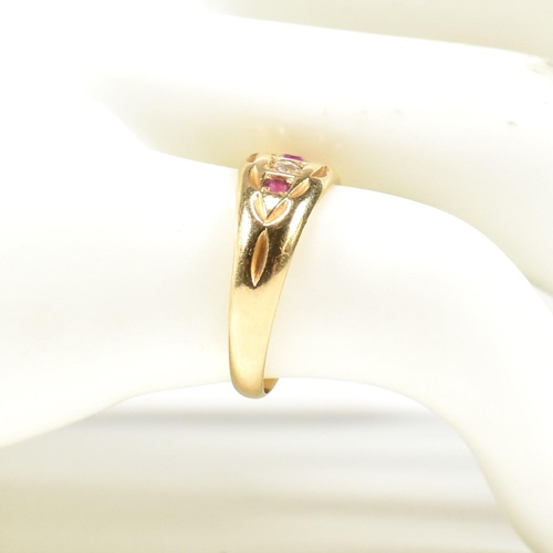 38 - A Victorian hallmarked 18ct gold ruby and diamond gypsy ring. The ring set with three rubies and two... 