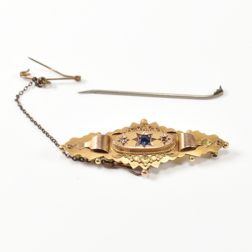 388 - A hallmarked 9ct gold, sapphire and white stone brooch pin. The brooch pin having a central star set... 