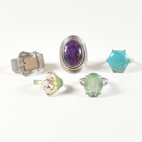 390 - A collection of 925 silver, gem set and enamel rings. The rings to include a silver and gradient-col... 