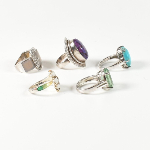 390 - A collection of 925 silver, gem set and enamel rings. The rings to include a silver and gradient-col... 