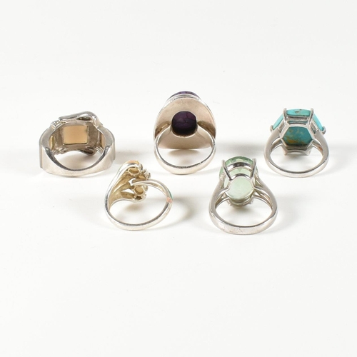 390 - A collection of 925 silver, gem set and enamel rings. The rings to include a silver and gradient-col... 