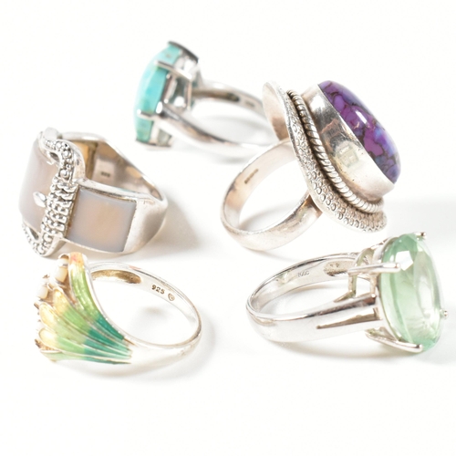 390 - A collection of 925 silver, gem set and enamel rings. The rings to include a silver and gradient-col... 