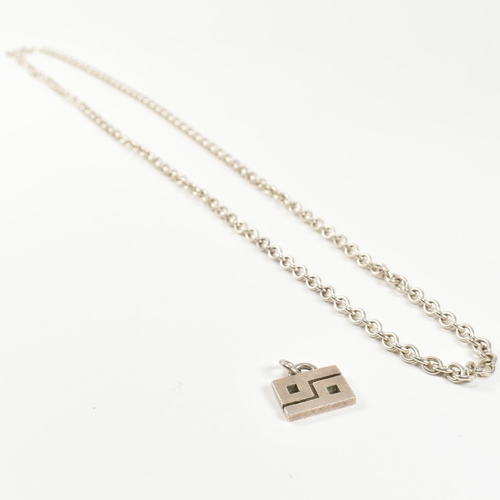 394 - A hallmarked silver Gucci necklace pendant and a silver chain necklace. The lot to include a hallmar... 